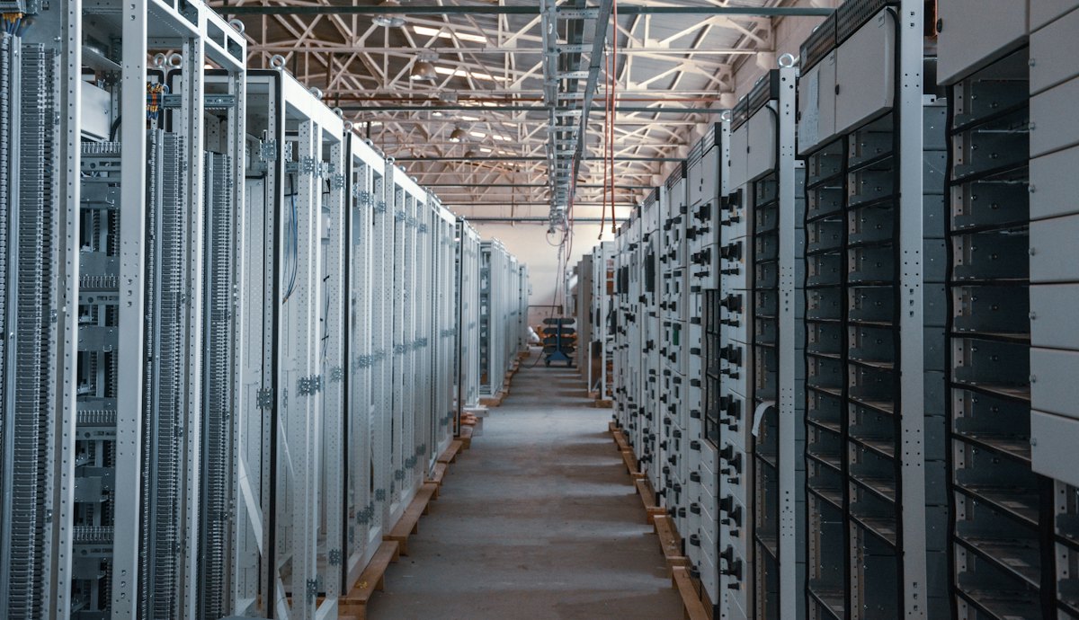 Server room aisle lined with equipment racks